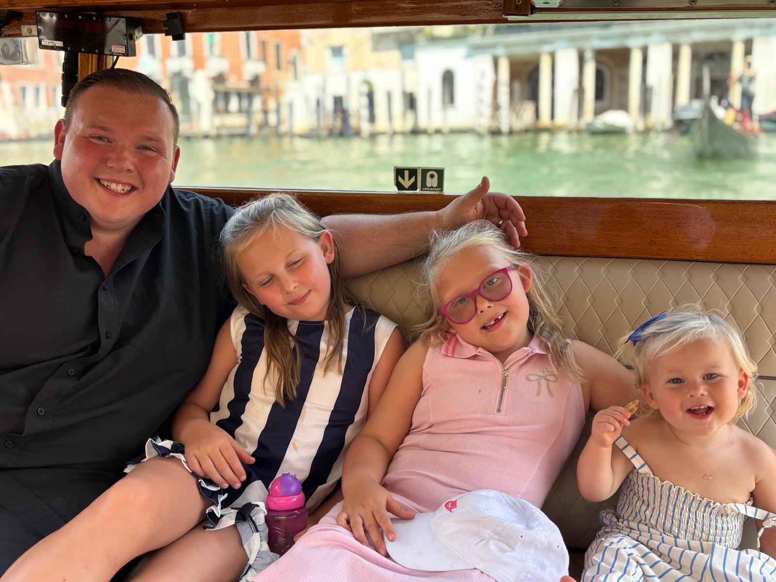 Ricky Oliver with his three daughters on a boat trip